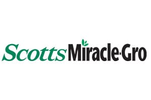 Flat wordmark on white: Scotts in green italic serif letters followed by Miracle-Gro in heavy black type, with two small green leaves sprouting from the letter i.