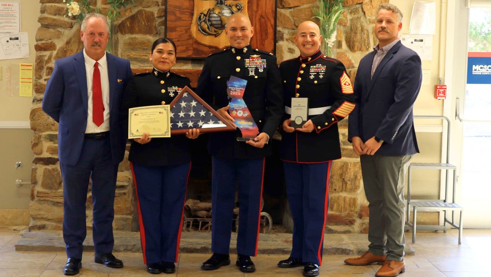 Service members accepting the America Recycles Day Hero Award at a presentation ceremony.
